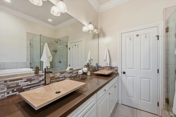 a bathroom with a sink double vanity and a mirror