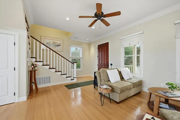 a living room with furniture and a wooden floor