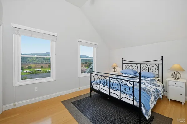 a view of a bedroom with furniture and window