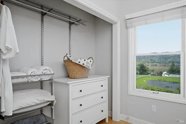 a room with a window and a dresser
