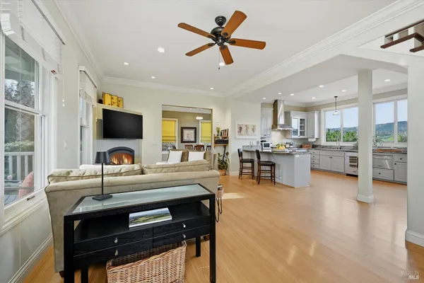 a kitchen with a table chairs refrigerator and microwave