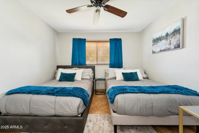 a bedroom with bed and a chandelier