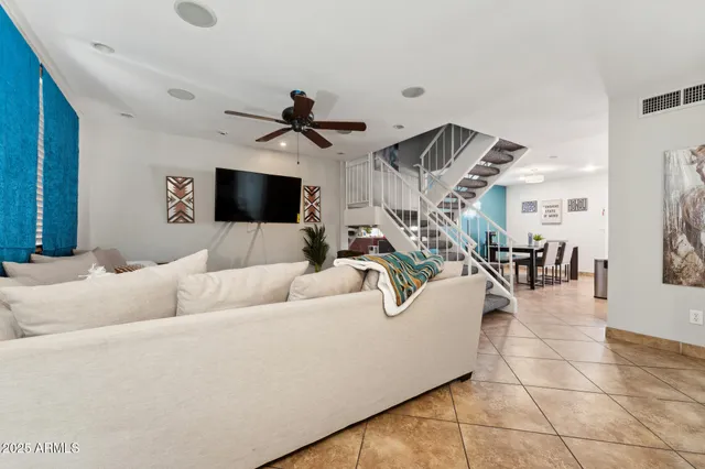 a living room with couches and a flat screen tv