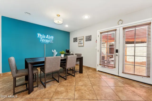a view of a dining room with furniture a rug and a window
