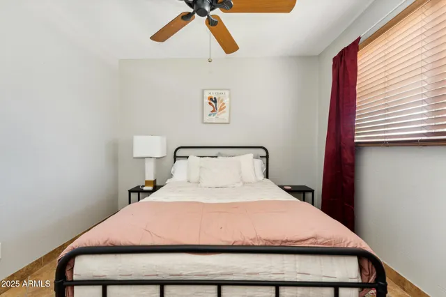 a bedroom with a bed and window