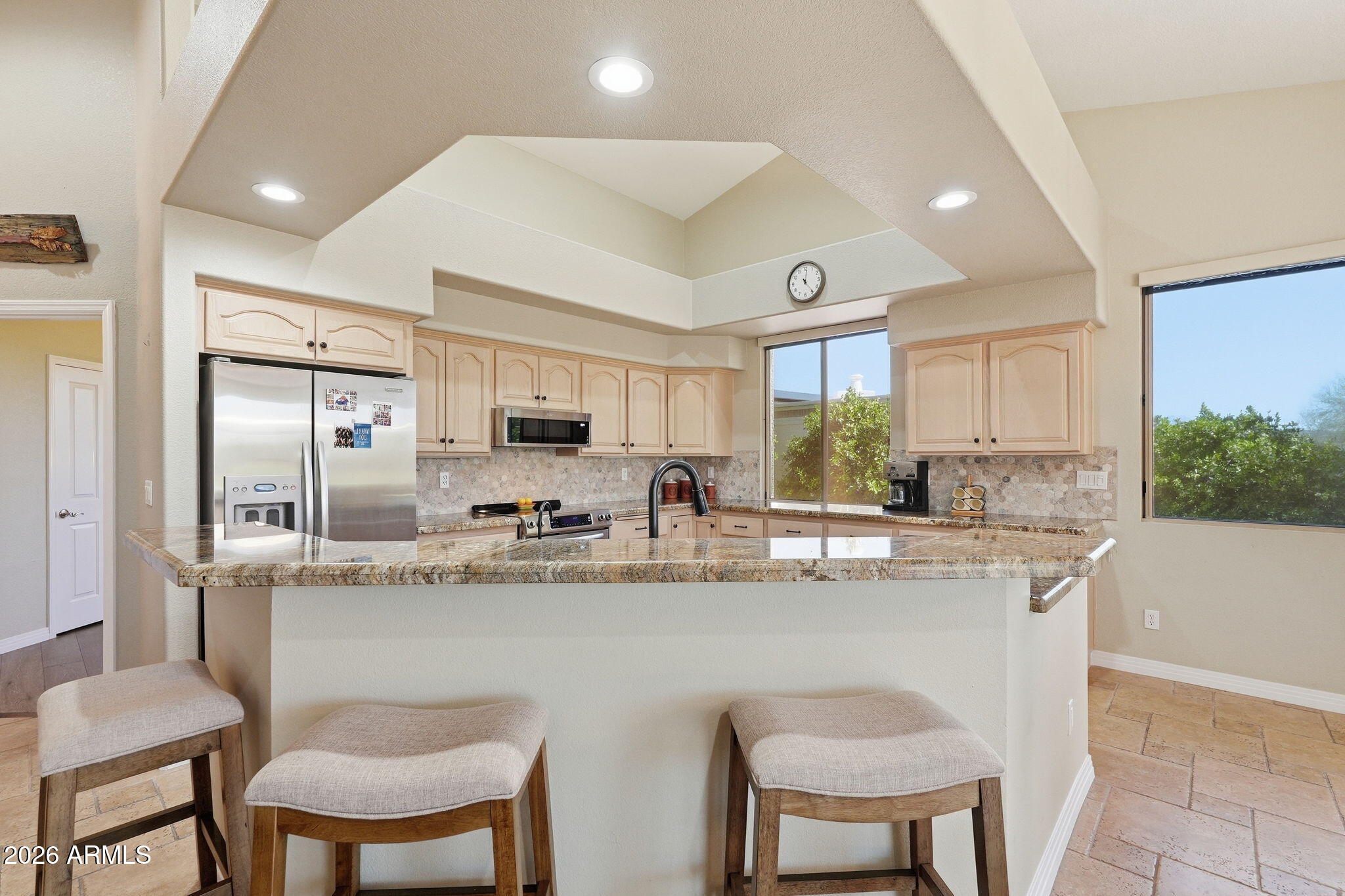 18809 East Avenida Del Ray Rio Verde, AZ 85263 - Photo 10 of 48 a kitchen with stainless steel appliances granite countertop a table chairs stove and refrigerator