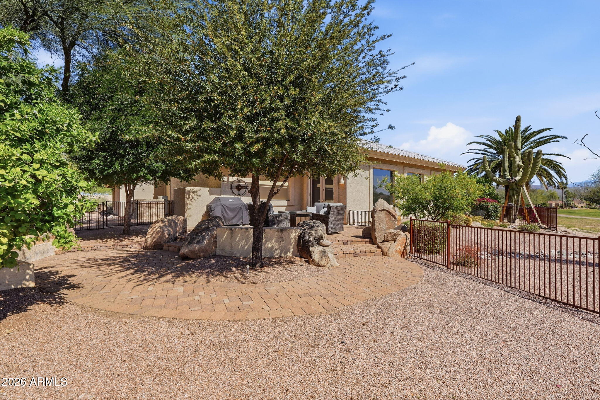 18809 East Avenida Del Ray Rio Verde, AZ 85263 - Photo 28 of 48 a view of backyard with a table and chairs and potted plants
