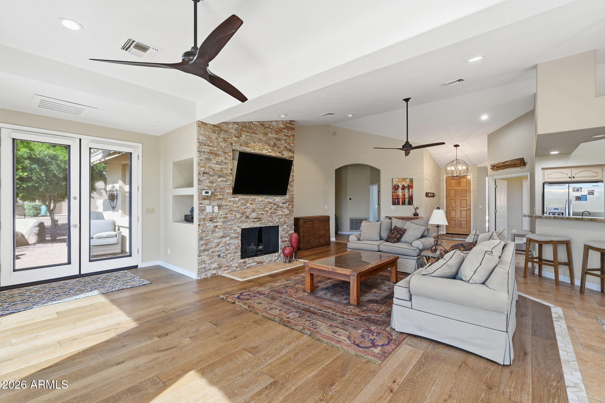18809 East Avenida Del Ray Rio Verde, AZ 85263 - Photo 3 of 48 a living room with furniture a fireplace and a flat screen tv