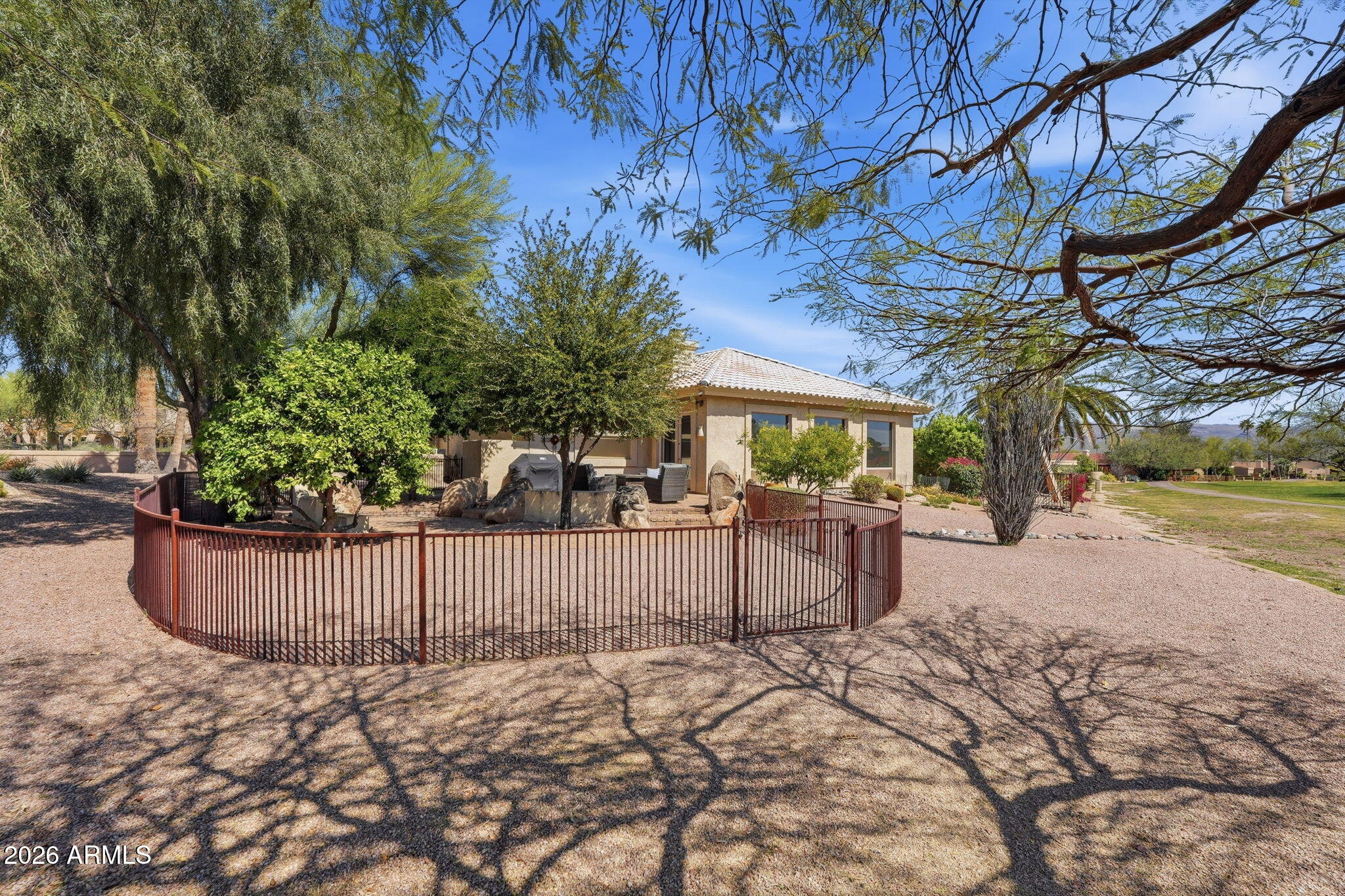 18809 East Avenida Del Ray Rio Verde, AZ 85263 - Photo 40 of 48 a view of a backyard with trees and wooden fence