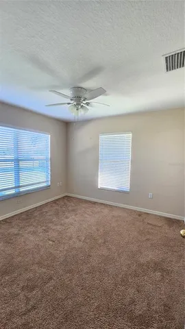 an empty room with a empty space and windows