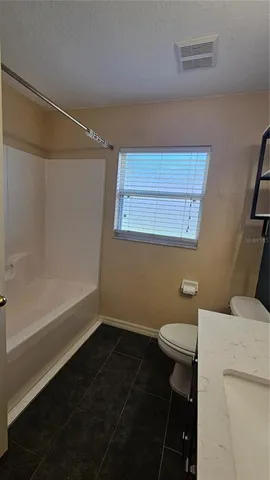 a bathroom with a sink a toilet a vanity and mirror