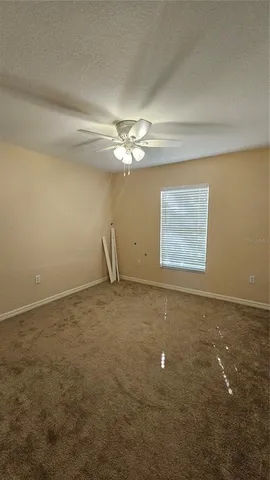 a view of a room with window and ceiling fan