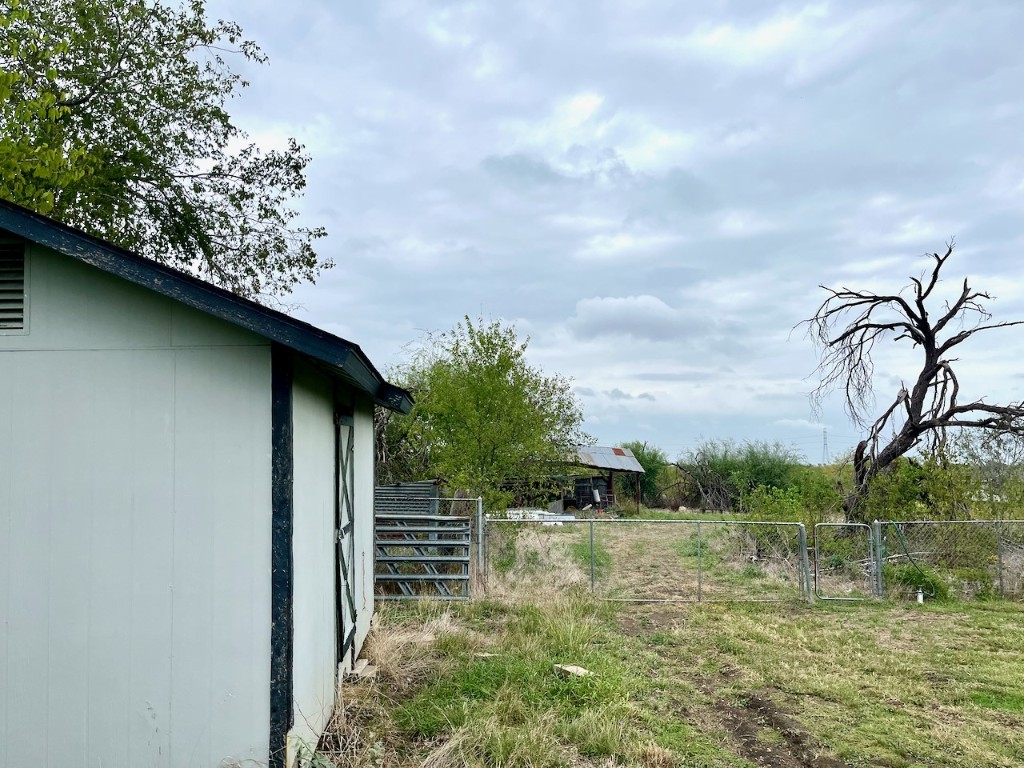 11604 Moore Road Austin, TX 78719 - Photo 10 of 19 a backyard of a house with lots of green space and lake view