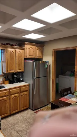 a view of a kitchen counter top a sink and cabinets