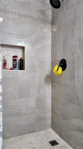 a bedroom with a bed and curtain