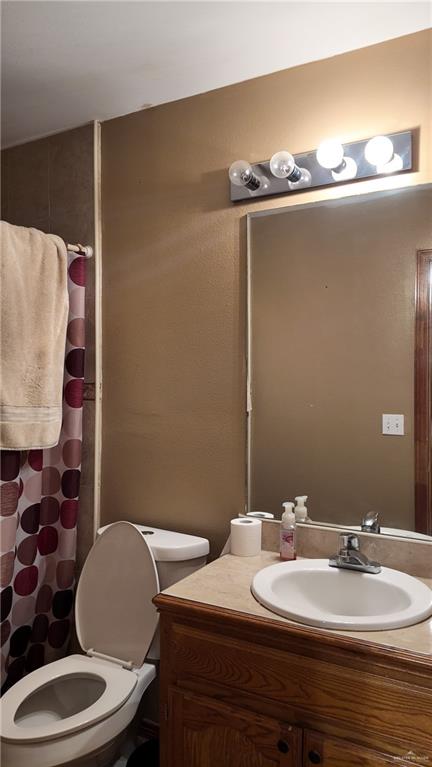 191 Teodora Drive Rio Grande City, TX 78582 - Photo 28 of 45 a bathroom with a sink mirror vanity and toilet
