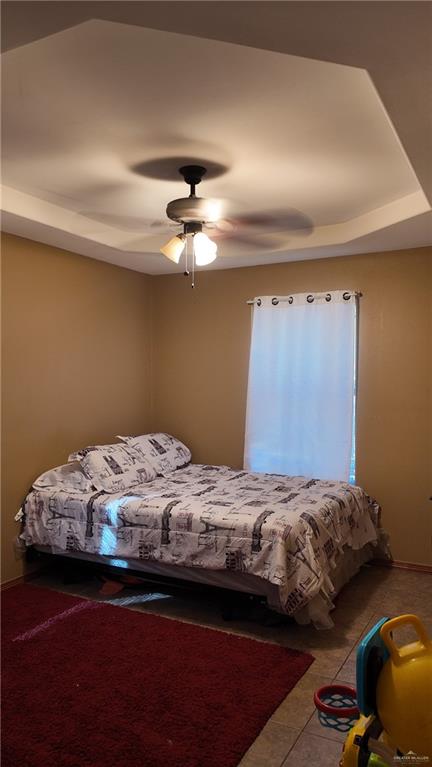 191 Teodora Drive Rio Grande City, TX 78582 - Photo 34 of 45 a bedroom with a bed and a chandelier