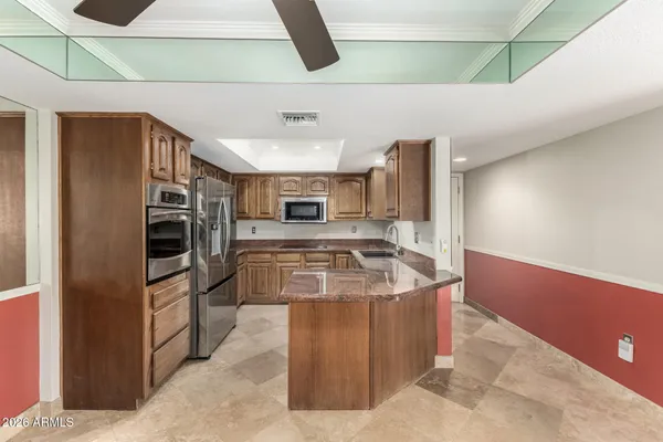 a kitchen with stainless steel appliances granite countertop a stove and a refrigerator