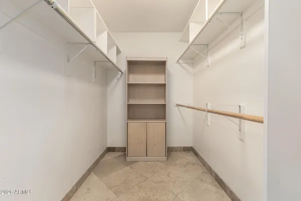 a bathroom with a granite countertop double vanity and a large mirror