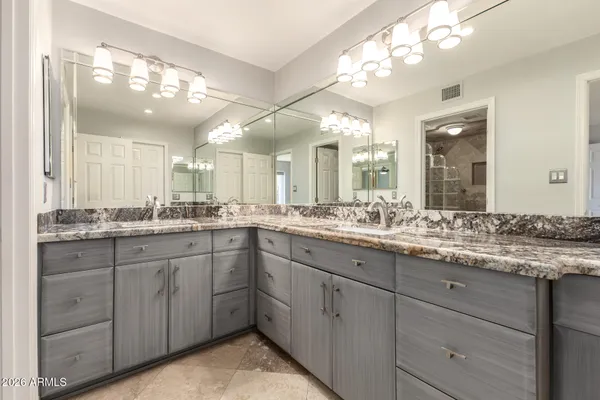 a bathroom with a granite countertop sink a toilet and a mirror