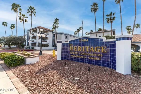 a view of a grey house with large windows