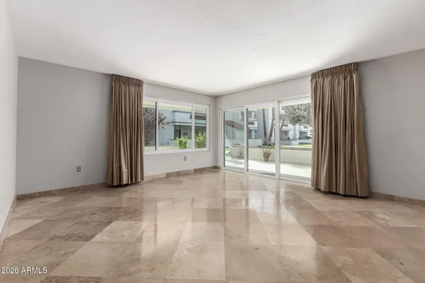 a view of an empty room with glass door