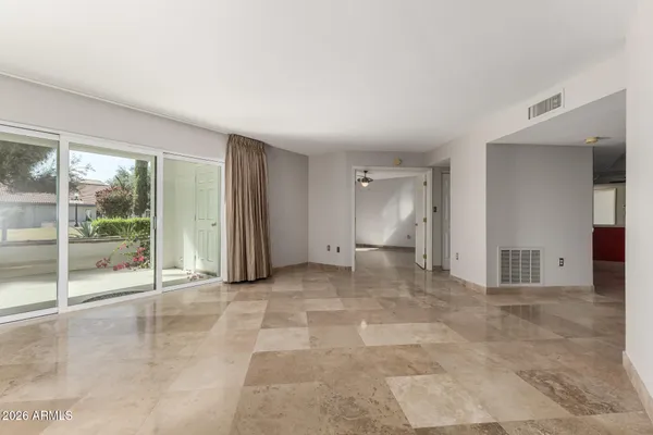 a view of a big room with windows and entryway