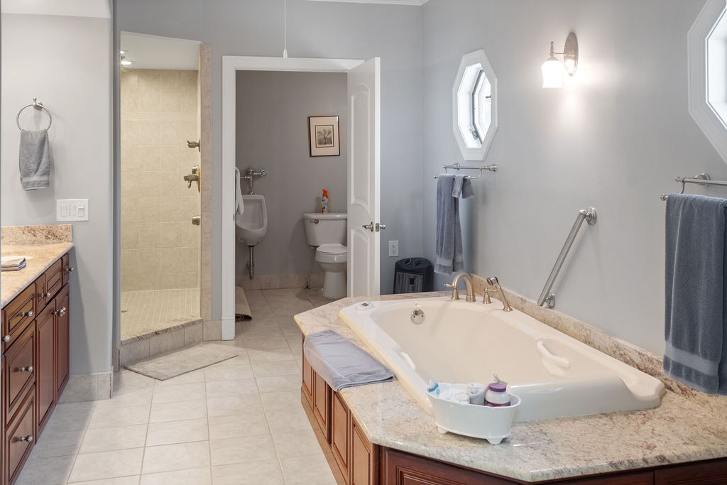 758 Holt Road Lebanon, TN 37087 - Photo 31 of 55 a bathroom with a tub a sink and a large mirror