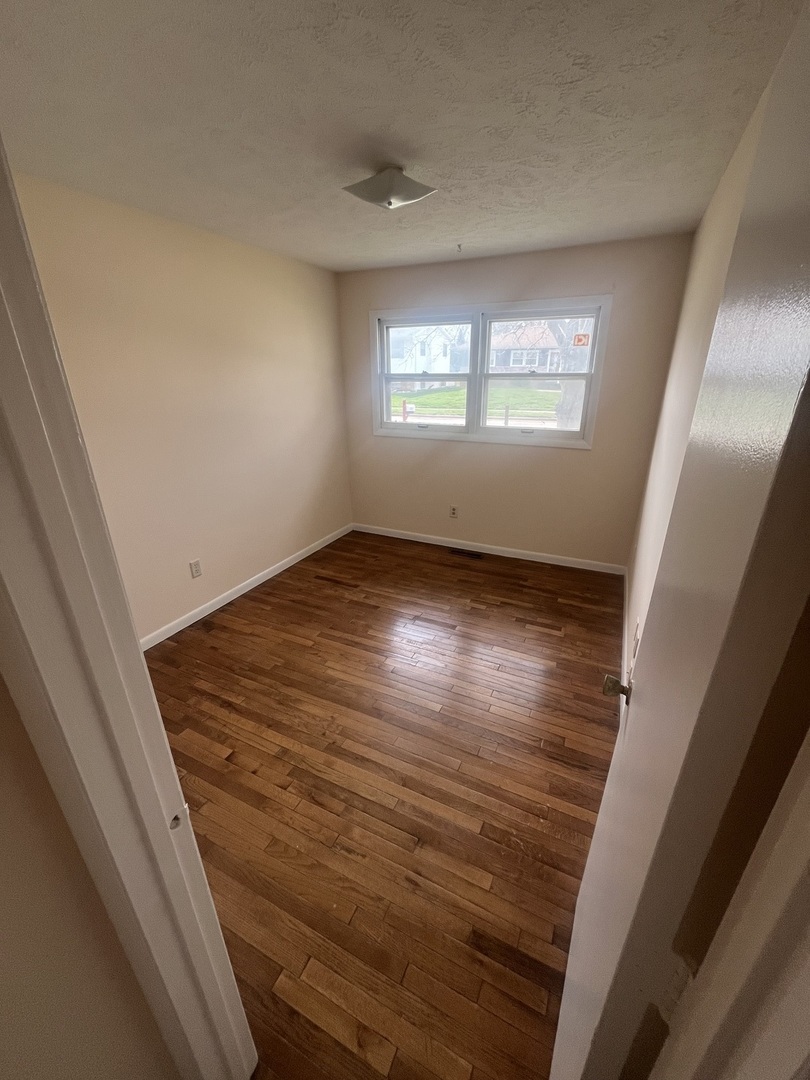 1720 Jacobssen Drive Normal, IL 61761 - Photo 6 of 13 a view of an empty room and window