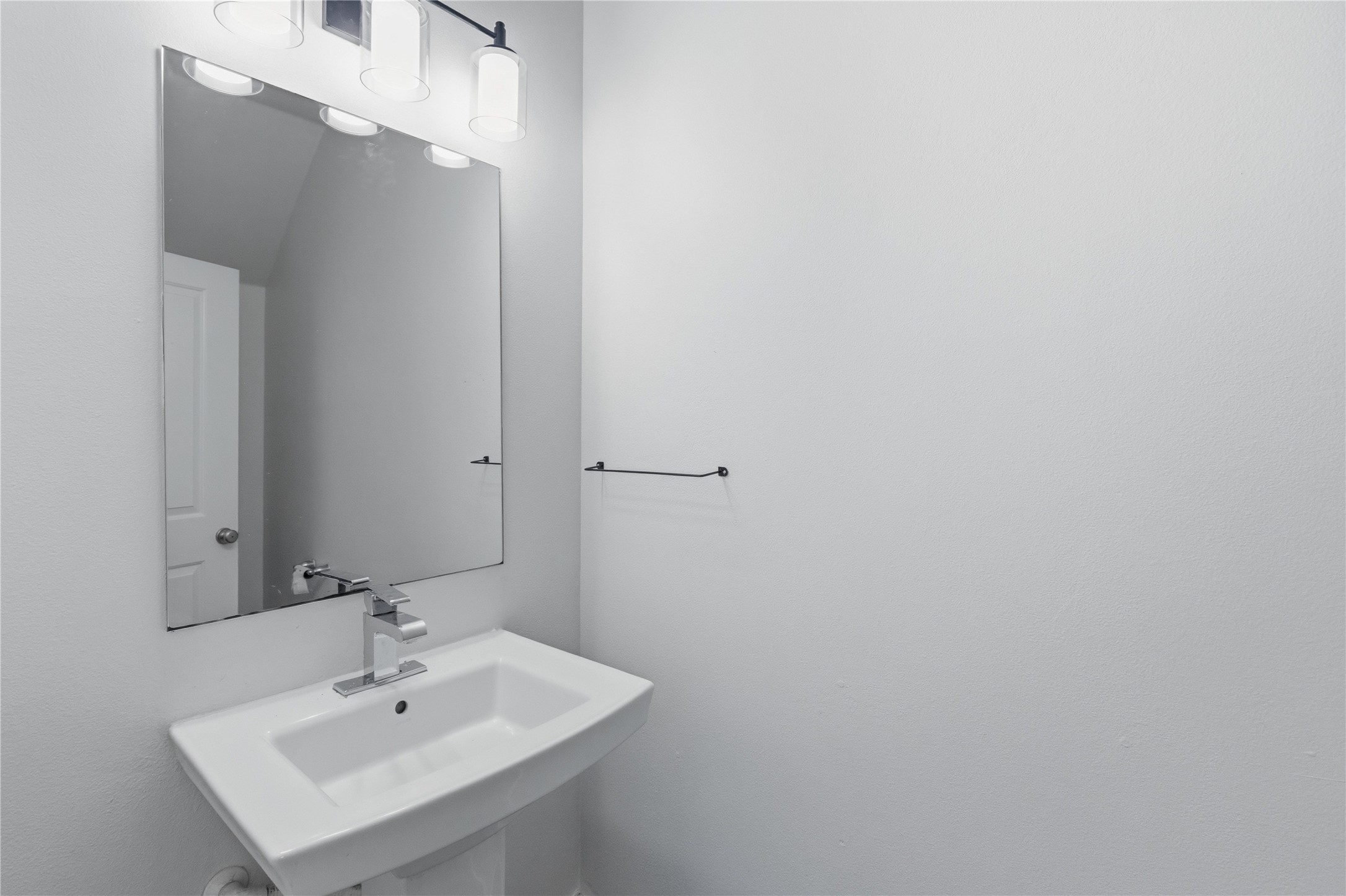 4124 Valley View Road, Unit 4A & 4B Austin, TX 78704 - Photo 29 of 40 A sleek pedestal sink and frameless mirror elevate this pristine powder room.