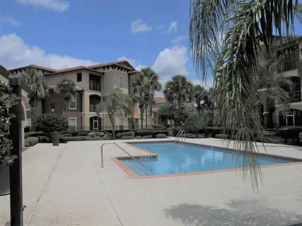 a view of a house with swimming pool and sitting area