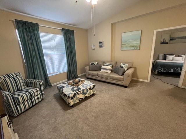 5512 Metrowest Boulevard, Unit 304 Orlando, FL 32811 - Photo 3 of 12 a living room with furniture and a window