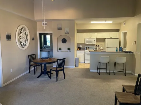 a dining room with a table chairs and a large window