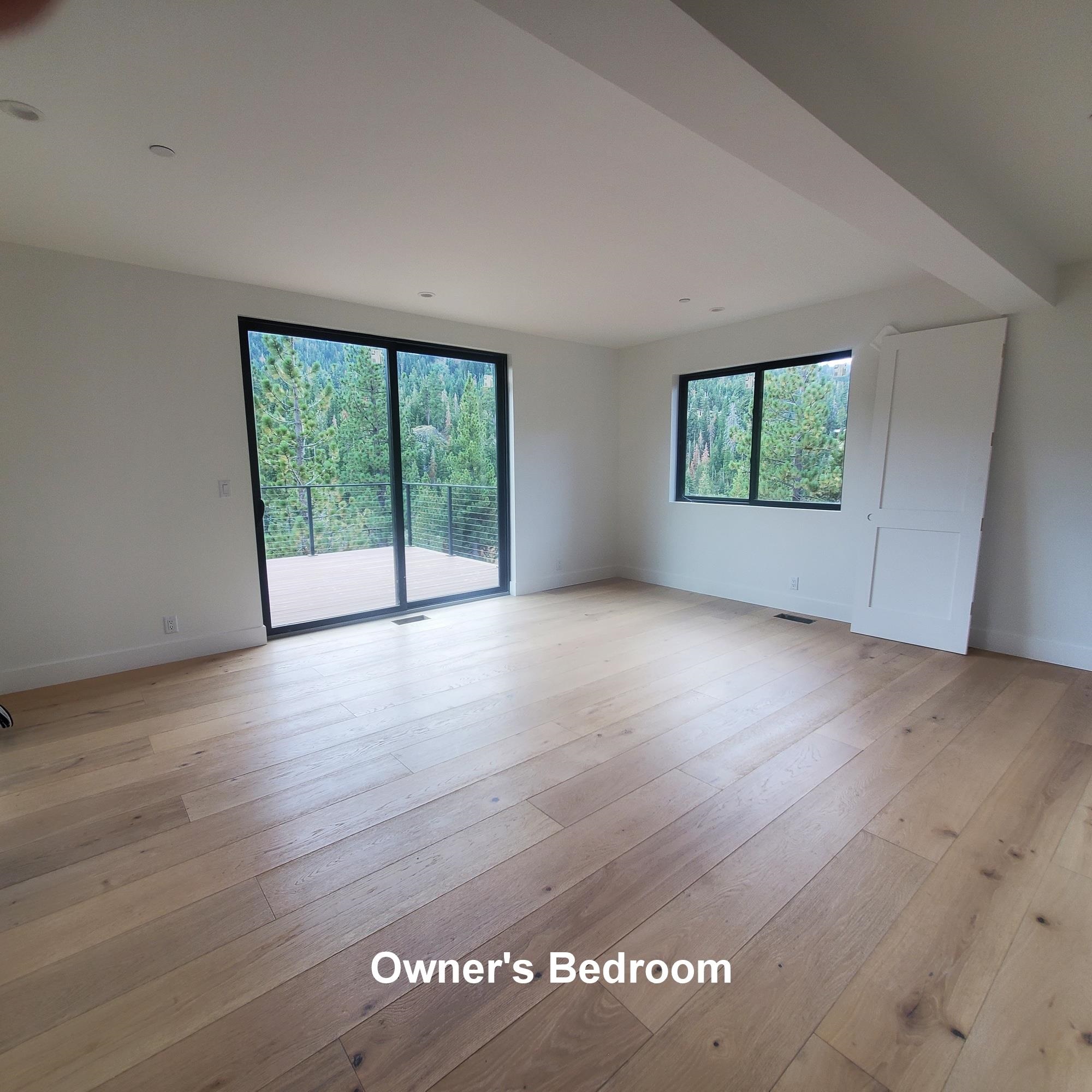 1423 Juniper Mountain Road Alpine Meadows, CA 96146 - Photo 4 of 8 an empty room with wooden floor and windows