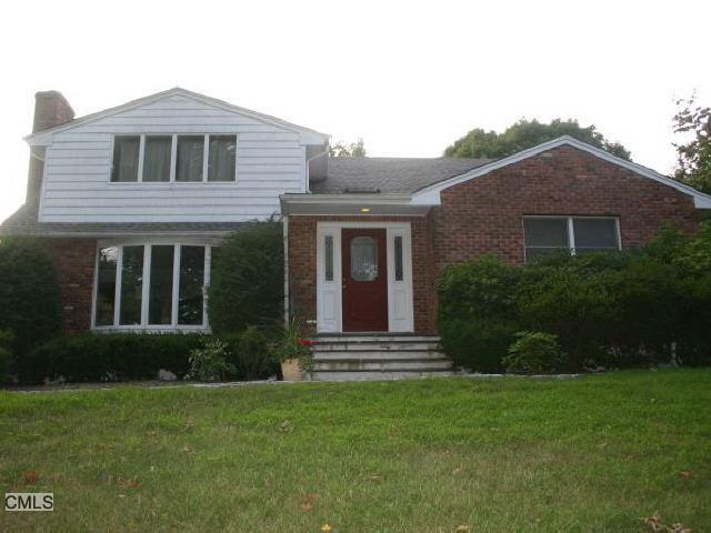 536 Stillwater Road Stamford, CT 06902 - Photo 1 of 1 a front view of a house with a yard
