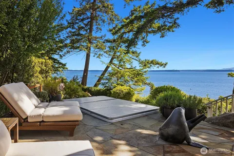 a backyard of a house with table and chairs