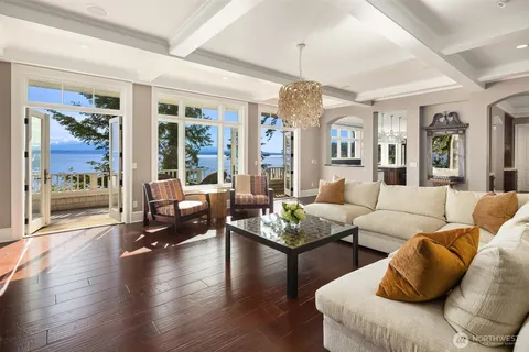 a living room with furniture a chandelier and a fireplace