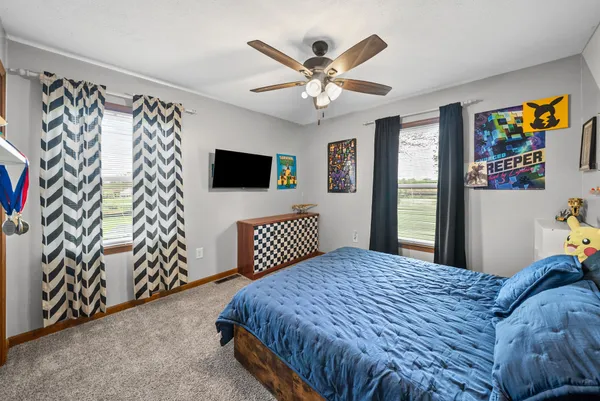 a bedroom with a bed and a chandelier