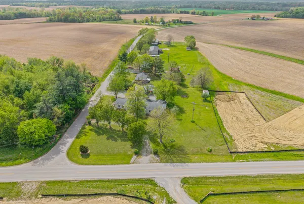 a view of a house with a large tree and a big yard