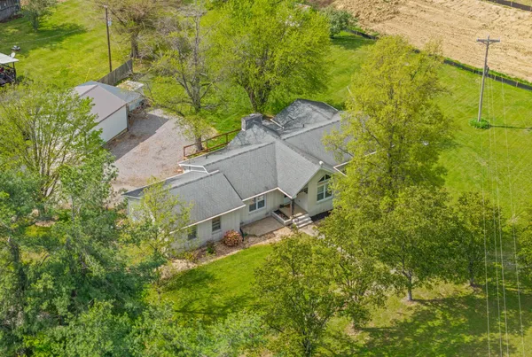 an aerial view of a residential houses with outdoor space and swimming pool