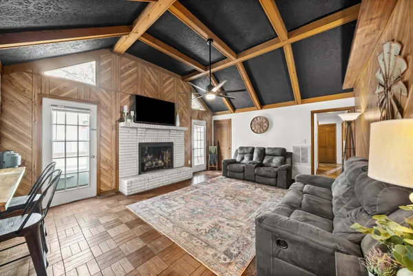 a view of a couches with wooden roof and stairs