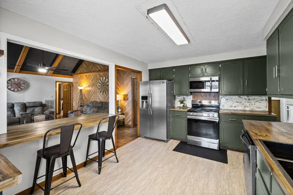 a kitchen with a sink stainless steel appliances and cabinets