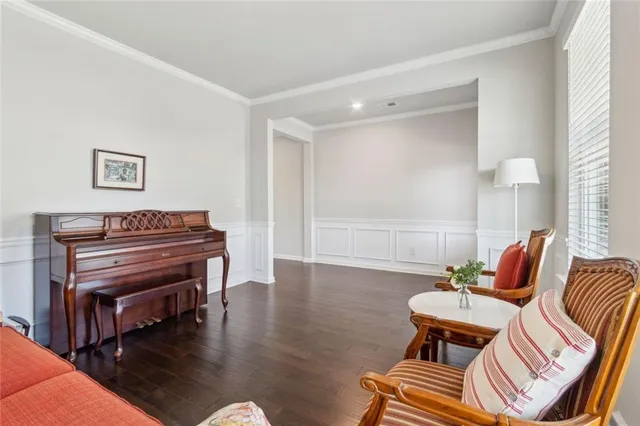 a living room with furniture and a piano