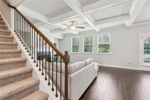 a view of staircase with wooden floor and fan