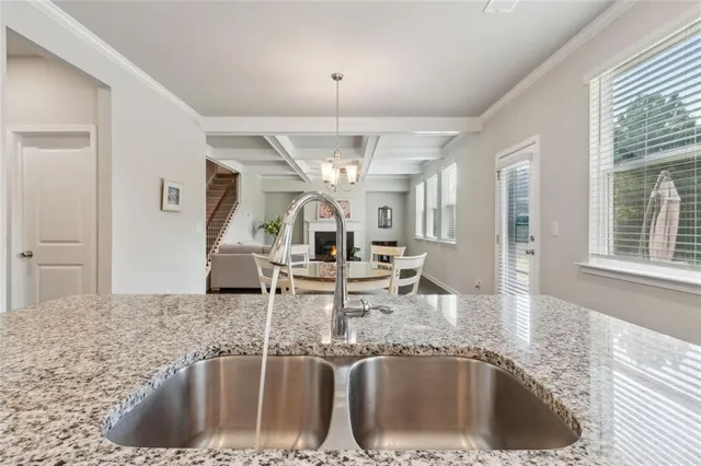 a kitchen with a faucet a sink and chandelier