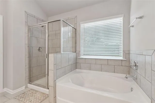 a white bath tub sitting next to a shower