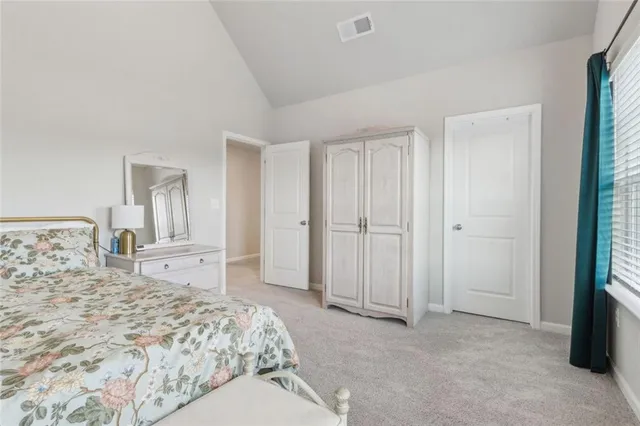 a bedroom with a bed and a large mirror