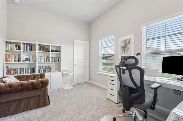 a view of a livingroom with workspace and a window