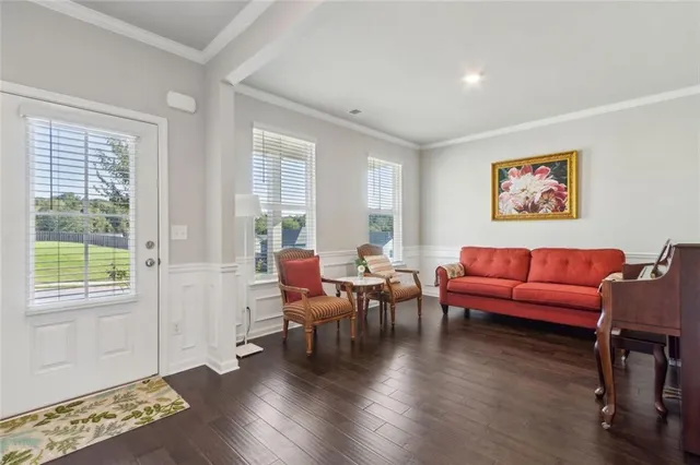 a living room with furniture and wooden floor