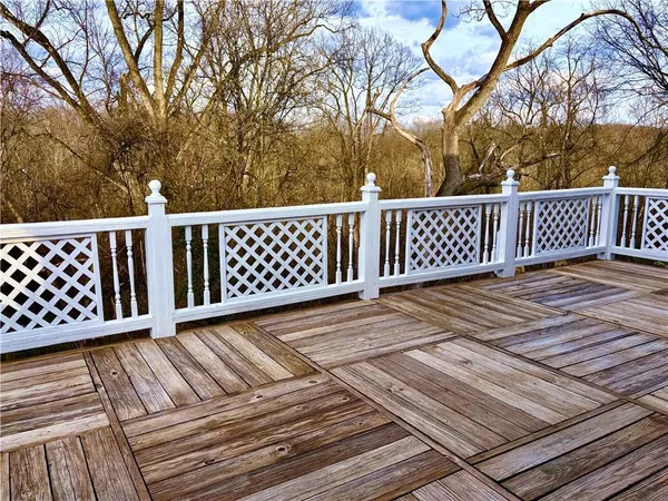 a view of deck with wooden floor and fence
